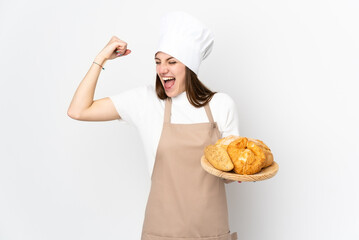 Young woman in chef uniform isolated on white background celebrating a victory