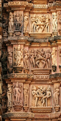 Fototapeta premium Close up of artful carved walls, Ancient reliefs at famous erotic temple in Khajuraho, Madhya Pradesh, India.