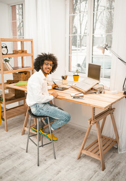 Workplace Near Window. Creative Man Looking At Camera Working With Laptop At Home Office Interior. Freelance Concept. Tinted Image.