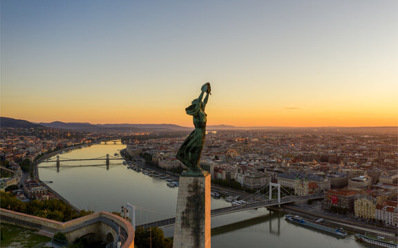 Europe Hungary Budapest Citadella. Liberty statue. Budapest cityscapes form Gellert Hill. Aerial view of the beautiful Hungarian Statue of Liberty with Liberty Bridge and skyline of Budapest at sunris