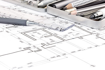 pens, ruler and other drawing tools on blueprints plan backgrounds 