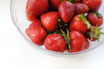 Summer vitamin fruits in a bowl. Appetizing strawberry close up background. 