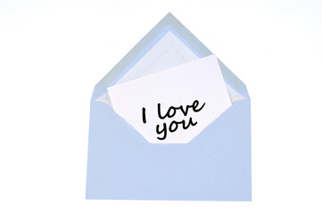 I love you written on a card in an envelope on a white background