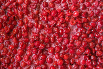 Background of fresh pitted cherries.  Fragrant cherry in its juice for jam. Homemade food concept. Hobby concept. Copy space. Top view.