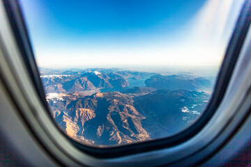 The view from the airplane window on a picturesque mountains landscape