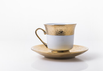 An arabic golden coffee cup with saucer.