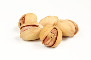 Group of raw and delicious pistachios in shell isolated on white background.
