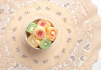 Bowl of Turkish Lokum- a Mediterranean sweet on elegant table matt. View from above.