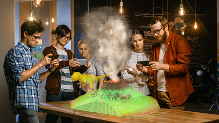 Group of Young Developers Look at Dinosaur and Volcano Eruption in Augmented Reality Through Smartphone. They're Working on the New Virtual Reality Game or Studying History and Geology.