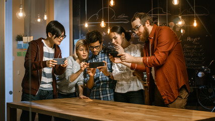 Great Concept For Augmented Reality Mock-up. Three Young Developers Look at Augmented Reality Through Smarthpone. They're Working on the New Virtual Reality Game.