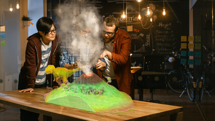 Two Young Developers Look at Dinosaur and Volcano Eruption in Augmented Reality Through Smartphone....