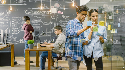 Shot of Busy Office. Young Creative People Work on Personal Computers, Draw Project Outline on...