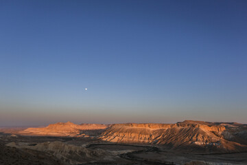 Panoramic view  of Nahal Zin, a 120 km long intermittent stream, the largest canyon in country, as seen at sunset from Sde Boker field school, Negev desert, Israel.