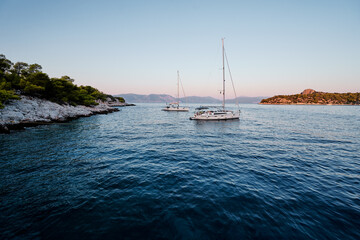 Beautiful landscape with yachts in blue lagoon.