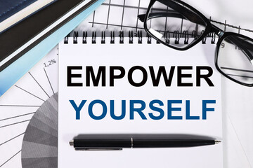 empower yourself. on a white background. against the background of financial charts, diaries, points. Business concept