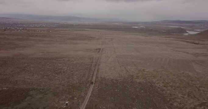 Aerial view of an off-road carcar rides on desert area near the city of Ulan-Ude, Siberia, Russia. DJI Mavic Pro 4K. 4x4