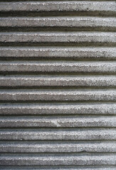 Grey concrete striped texture of wall. Close up detail of grey grunge cement wall.
