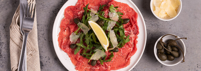 Marbled beef carpaccio with arugula, capers, lemon and parmesan cheese