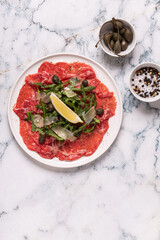 Marbled beef carpaccio with arugula, capers, lemon and parmesan cheese