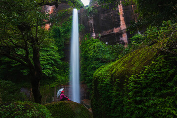 Young girl hiking in Tad-Wiman-Thip waterfall, Beautiful waterwall in Bung-Kan province, ThaiLand.