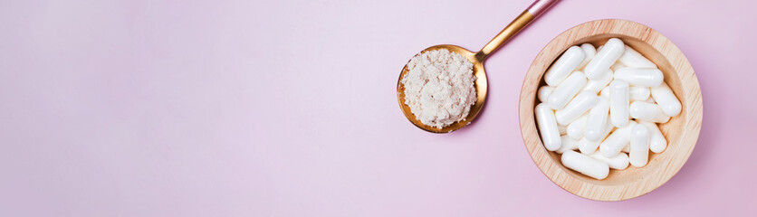 Collagen powder and pills on pink background