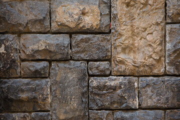 Old brick or stone wall. Antique brown wall different size brick masonry. Vintage texture or background.