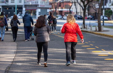 People walking along a path in a park during a pandemic in Buenos Aires