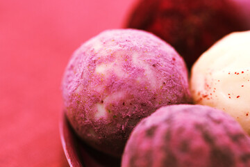 Defocused delicious chocolate pralines. Close up Horizontal View of Homemade Vegan Paleo Truffles, Luxury Healthy Dessert, Velvety Red Smooth Chocolate Truffles