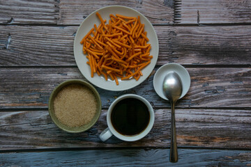 A cup of coffee And snacks On the old blue wood background