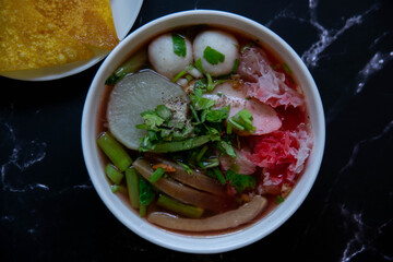 One type of noodles that has a mixture of red sauce is called Yentafo.