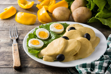 Traditional Peruvian papa a la huancaina on wooden table	