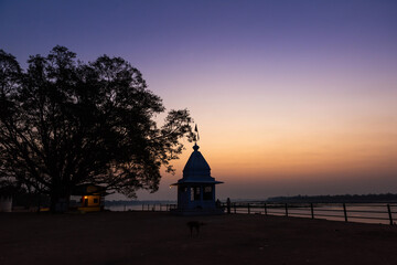Obraz premium Dusk time at Cheepaner Ghat with holy Narmada river and temple, Madhya Pradesh, India.