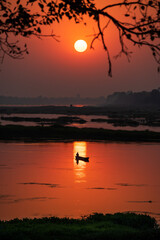 A colorful dawn over the river Narmada with sunrise at Cheepaner Ghat, Madhya Pradesh, India.