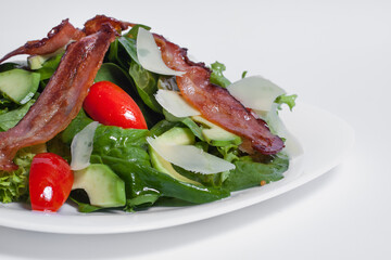 tasty green fresh salad with bacon isolated