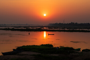 A colorful dawn over the river Narmada with sunrise at Cheepaner Ghat, Madhya Pradesh, India.