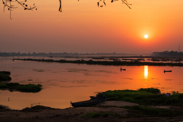 A colorful dawn over the river Narmada with sunrise at Cheepaner Ghat, Madhya Pradesh, India.