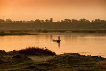 A colorful dawn over the river Narmada with sunrise at Cheepaner Ghat, Madhya Pradesh, India.