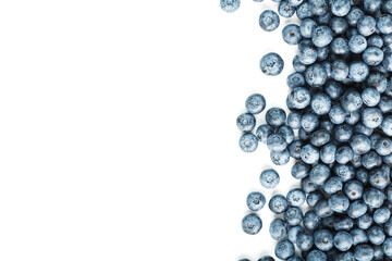Blueberries are scattered on a white background. Free space, isolate. Studio light.