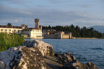 Sirmione Castle, Lake Garda Italy. Early morning historic city. Stones in the foreground