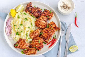 Grilled Chicken Thighs and Mashed Potatoes on a Plate Flat Lay Top Down Horizontal Photo