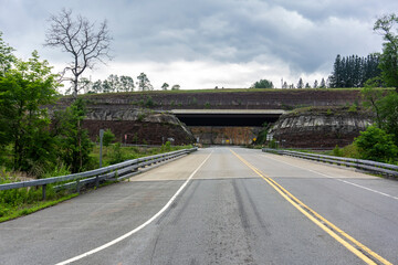 Road in Parksville, NY along walls of rocks. Exit toward highway 17 Empty road in ghost town...