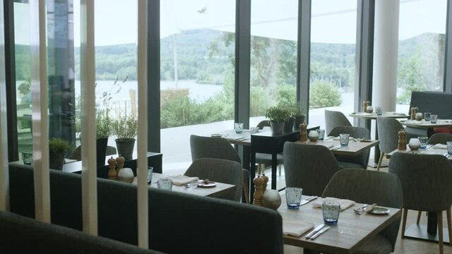 interior of a modern restaurant with a view on a beautiful lake .4K ProRes Footage