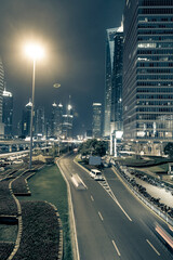 Fototapeta premium High-rise buildings, overpasses, and heavy vehicular traffic in the city center at night.