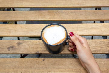 Hand holding coffee cup, selective focus