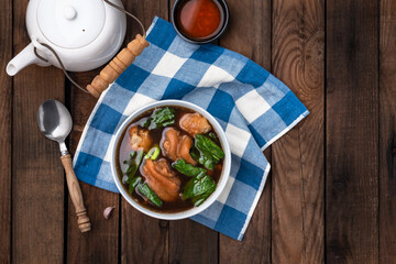 stewed pork leg in bowl on wood