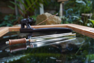 tuning fork with ganesha scent holder in the background