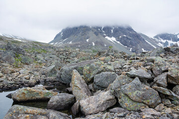 View of the area near The Lake Blavatnet, rocks, mountain and clouds, Lyngen Alps, Norway