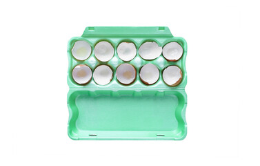Green egg carton/container with cracked egg shells isolated on white background