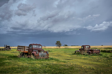 Old, abandoned vehicles on the Great Plains as Severe Weather Approaches