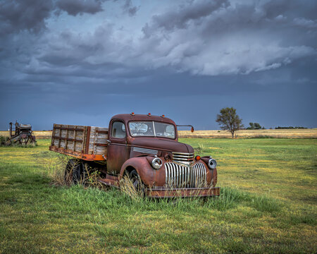 Old, abandoned vehicles on the Great Plains as Severe Weather Approaches